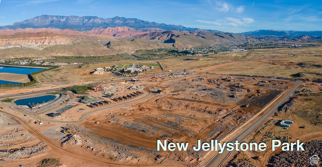 Birds eye view of property featuring a water and mountain view