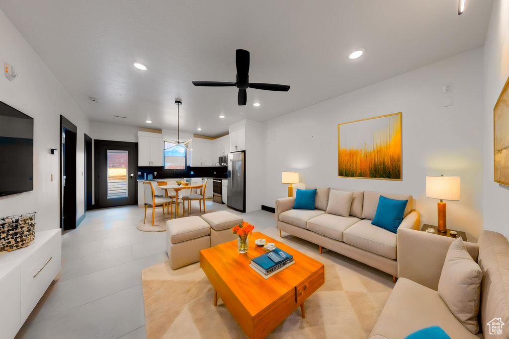 Living room featuring ceiling fan and light tile floors