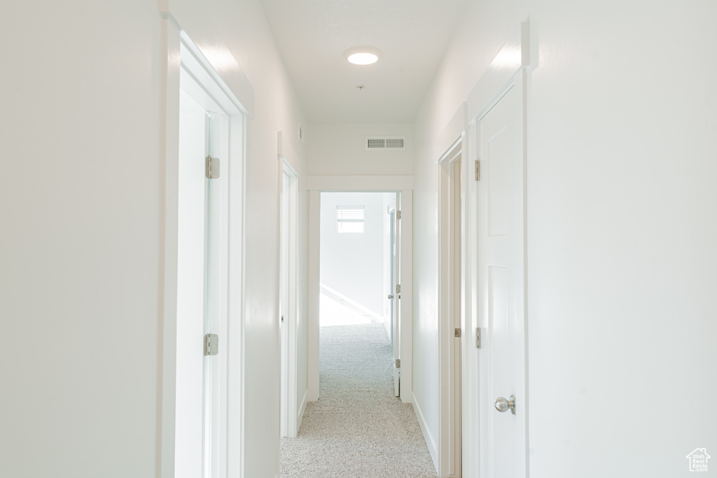 Hallway with light colored carpet