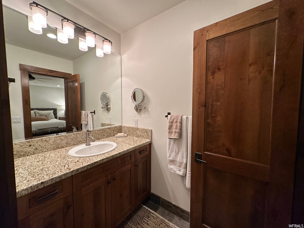 Bathroom featuring ceiling fan and vanity