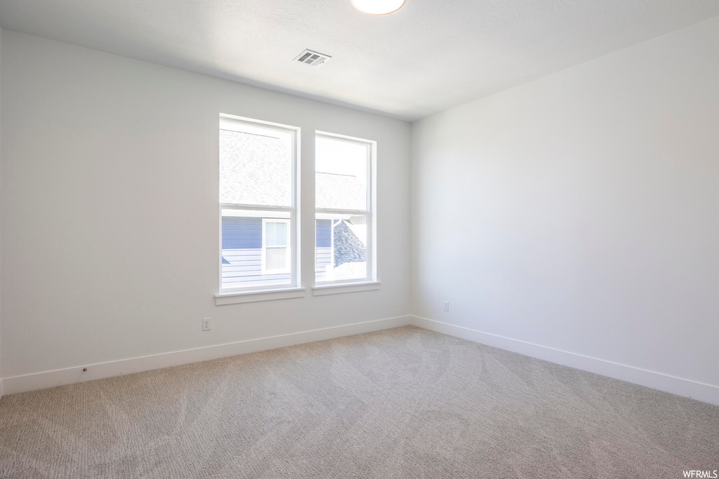 Carpeted empty room with plenty of natural light