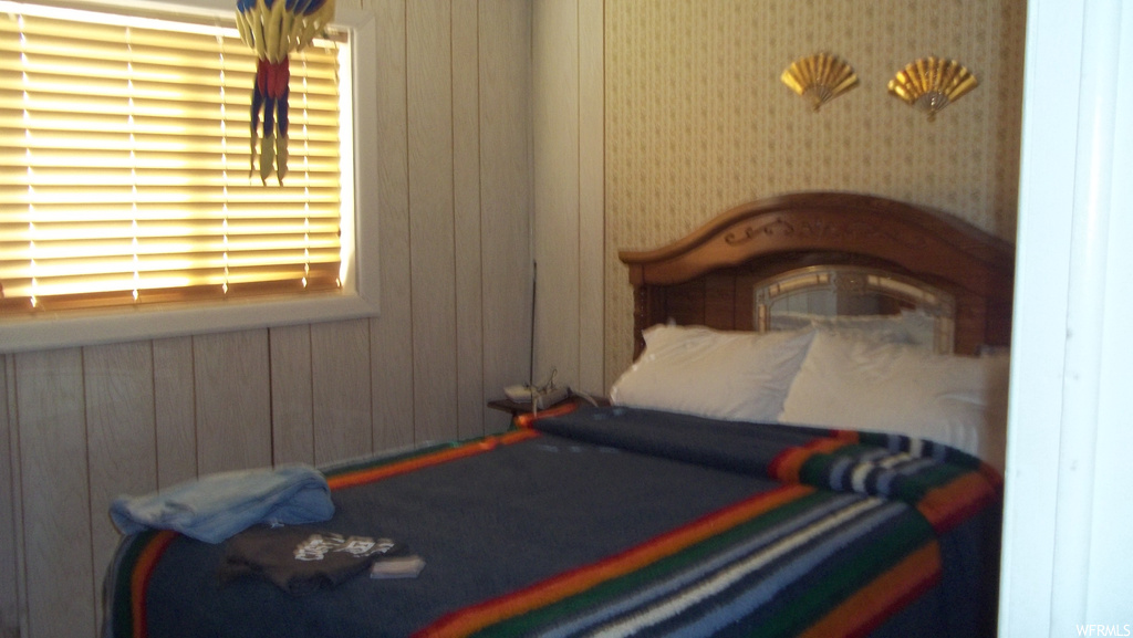 Bedroom with wooden walls