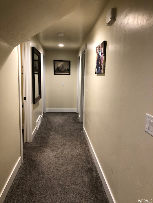 Hallway with dark carpet