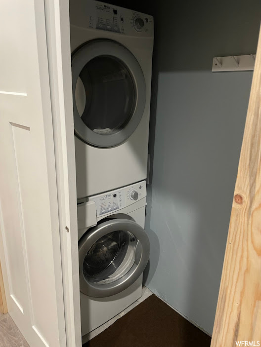 Washroom with stacked washer and clothes dryer