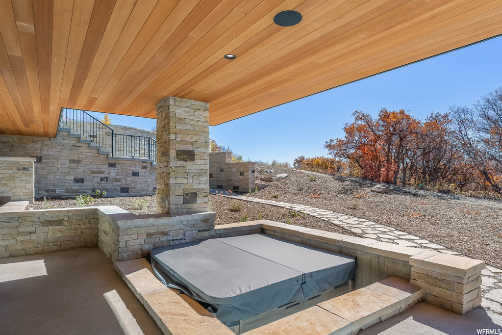 View of patio with a covered hot tub