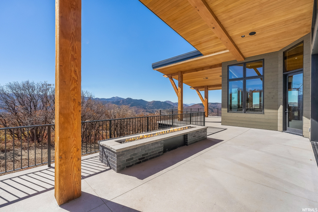 View of patio / terrace with a mountain view and a fire pit