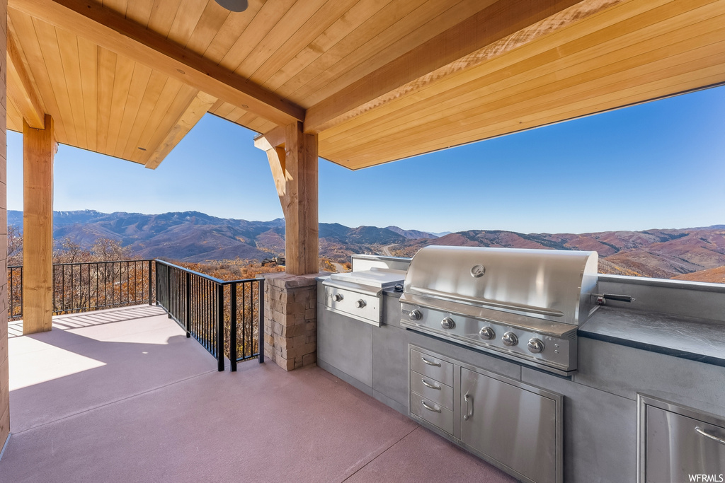 View of patio featuring area for grilling and a mountain view