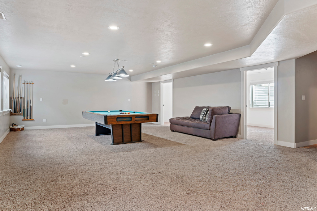 Recreation room with light carpet and pool table