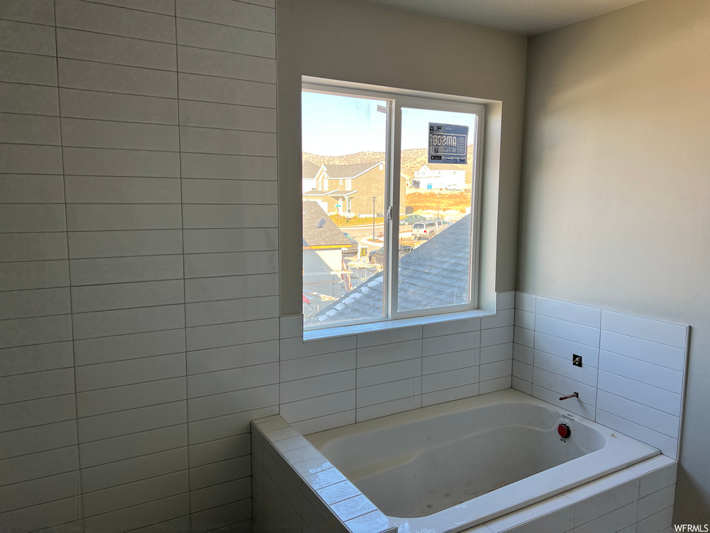 Bathroom featuring tiled bath