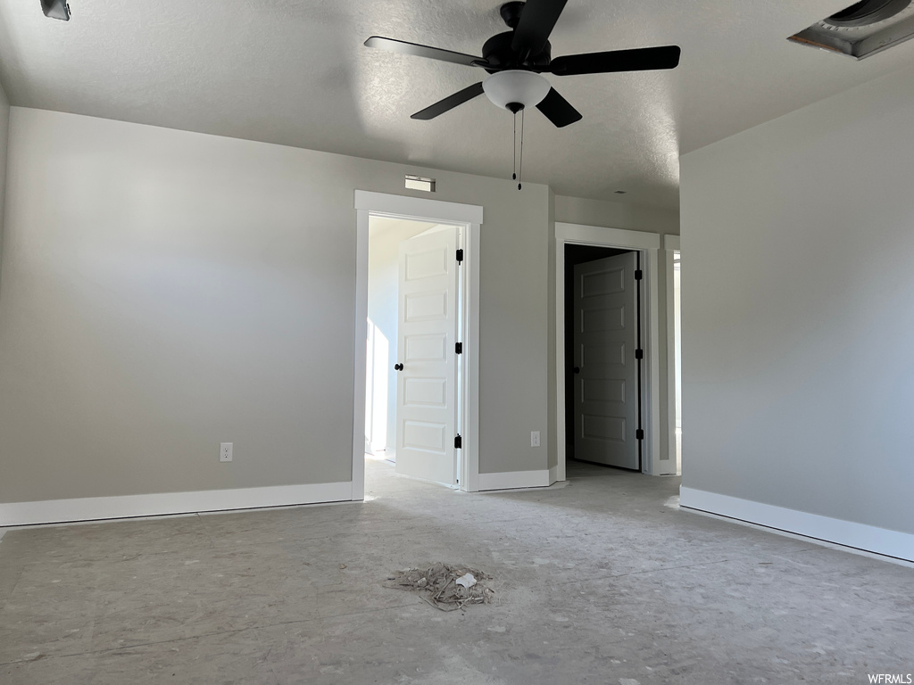 Empty room featuring ceiling fan