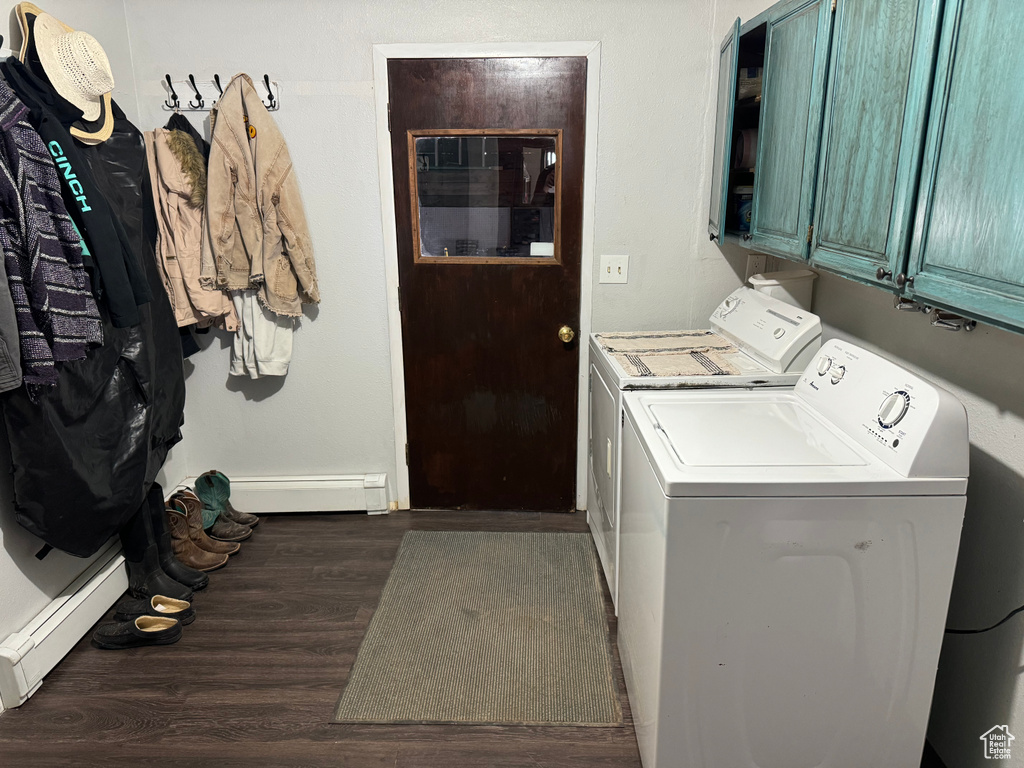 Laundry room with washing machine and dryer, dark hardwood / wood-style flooring, cabinets, and a baseboard heating unit