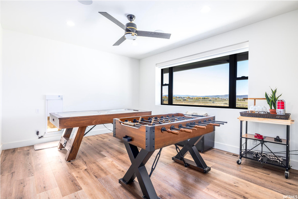 Recreation room with plenty of natural light, ceiling fan, and light hardwood / wood-style flooring