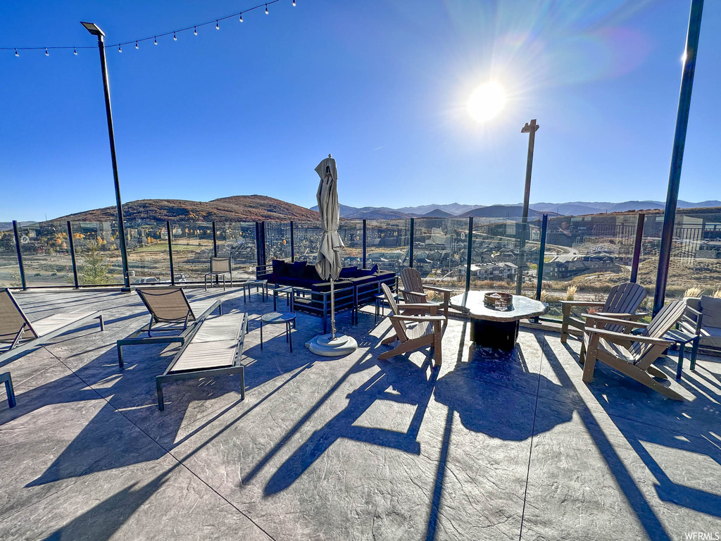 View of patio / terrace with an outdoor living space with a fire pit and a mountain view