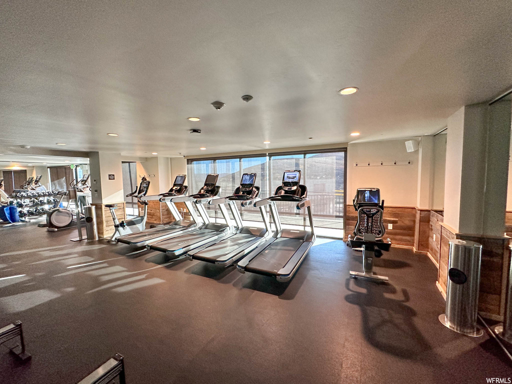 Gym featuring floor to ceiling windows and a textured ceiling