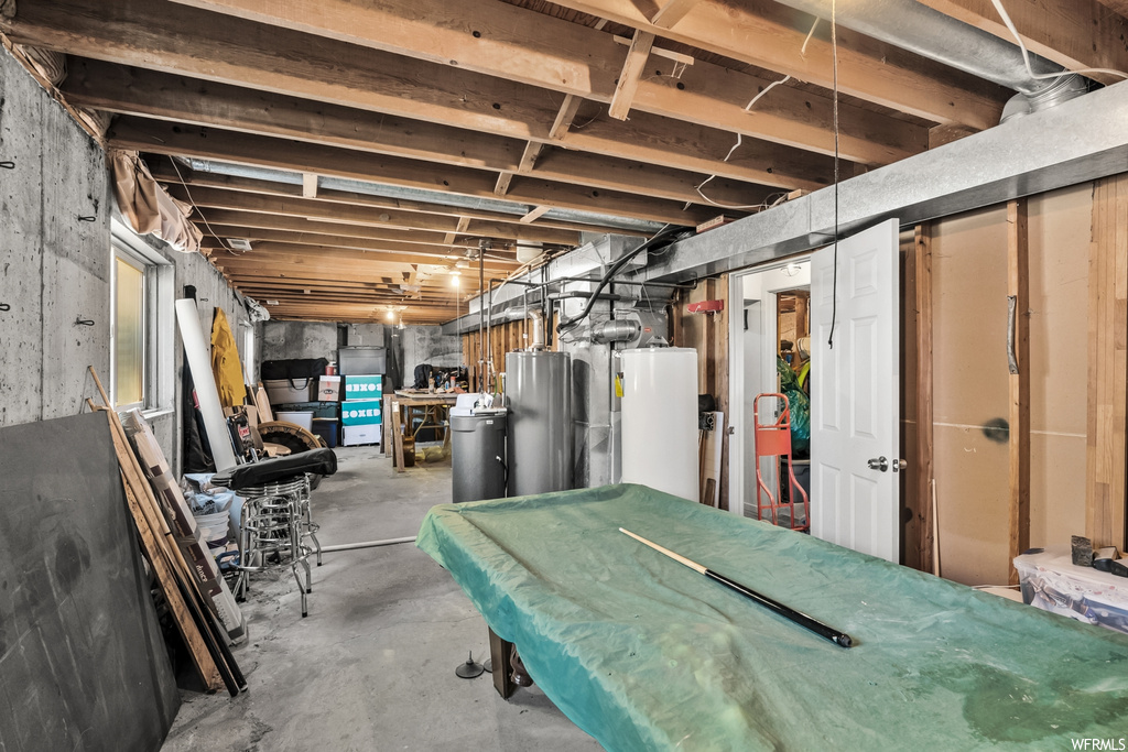 Basement featuring pool table and water heater