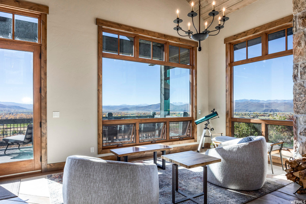 Living room with a mountain view and a notable chandelier