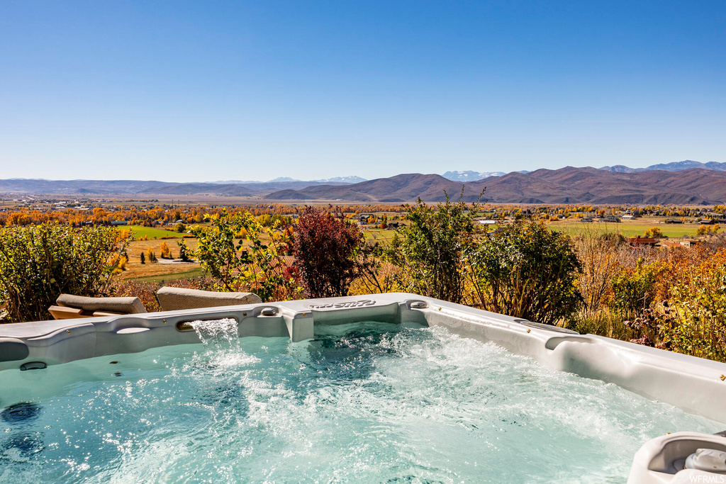 View of swimming pool featuring a mountain view and an outdoor hot tub
