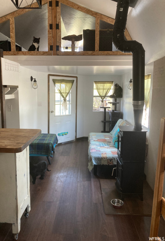 Hardwood floored bedroom with a wood stove