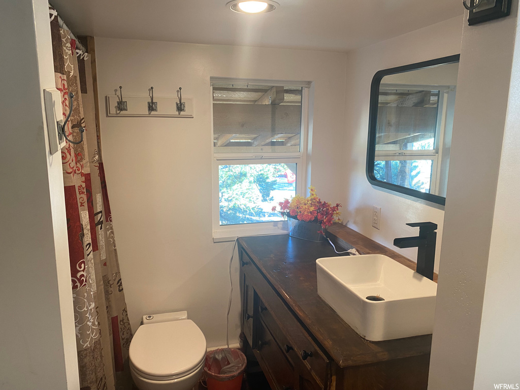 Bathroom with large vanity and toilet