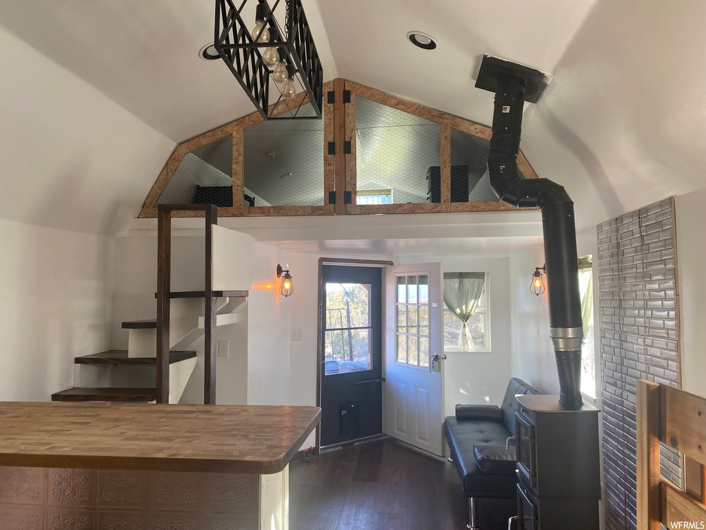 Kitchen with a wood stove, dark hardwood / wood-style flooring, and wood counters