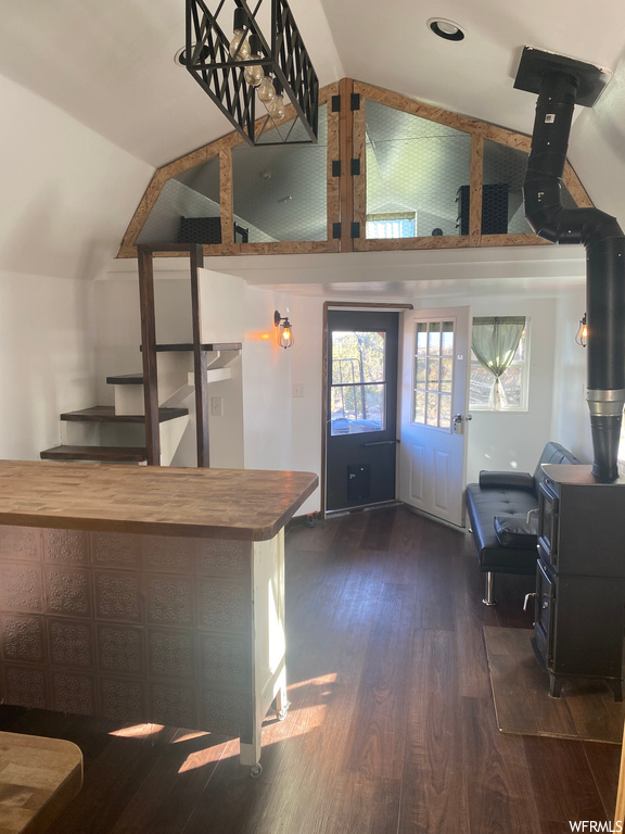 Kitchen with wooden counters, a wood stove, and dark hardwood / wood-style floors