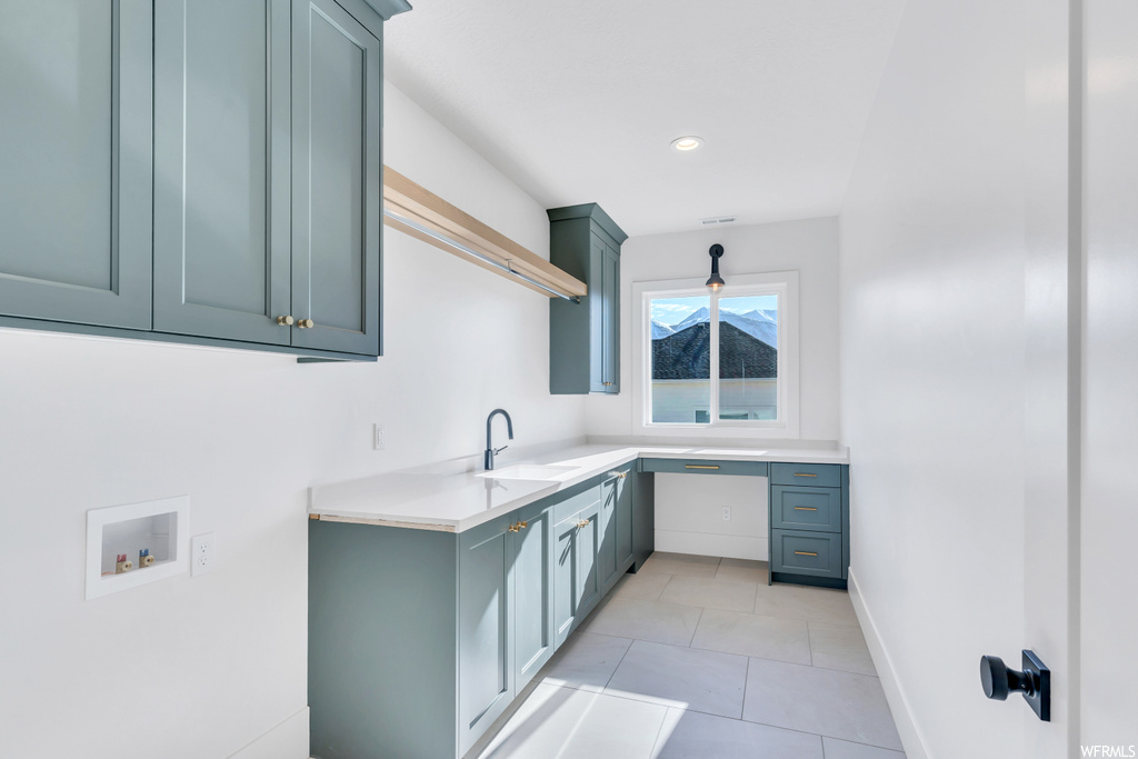 Kitchen featuring light tile flooring and sink