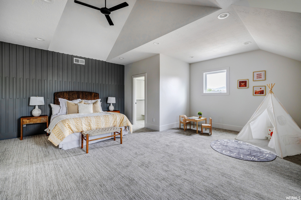 Bedroom featuring ceiling fan, lofted ceiling, and light colored carpet