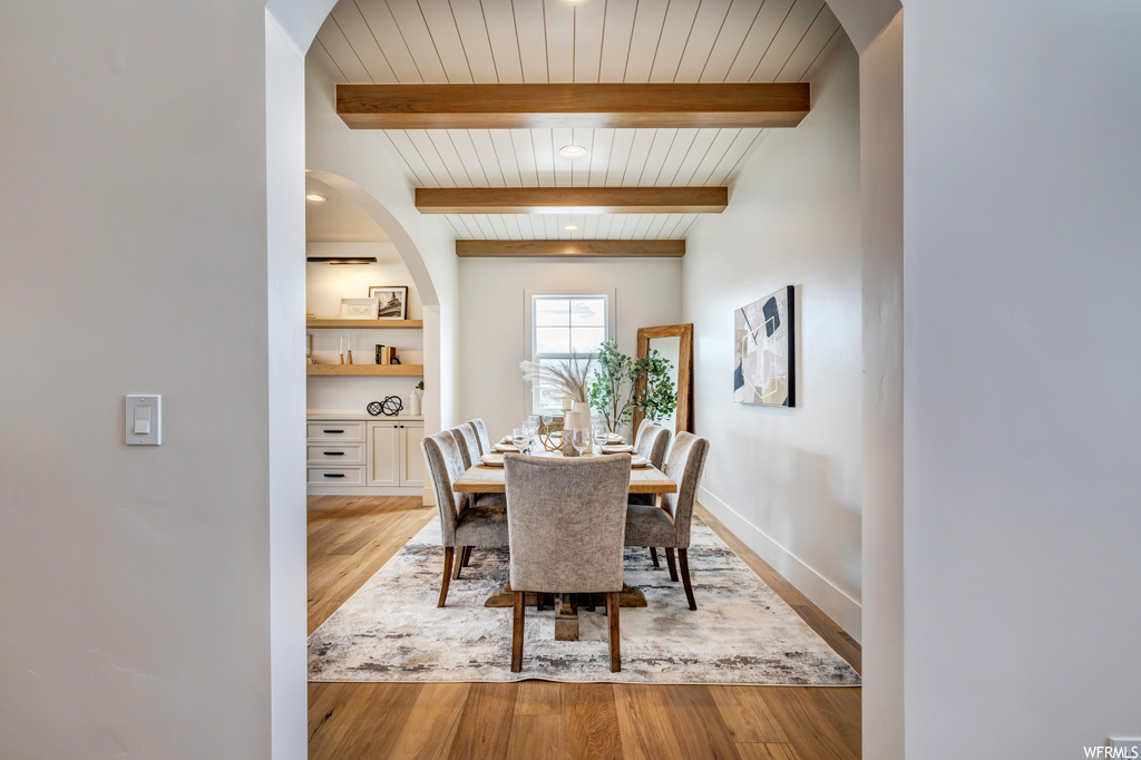 Dining room featuring beam ceiling and hardwood / wood-style flooring