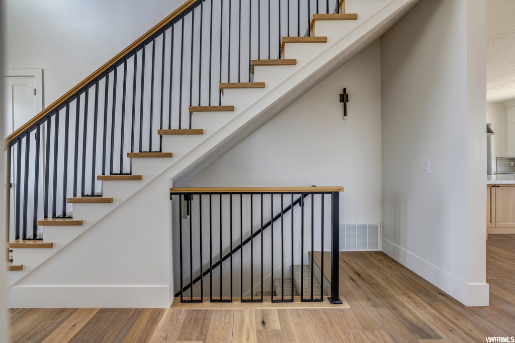 Stairway with light wood-type flooring