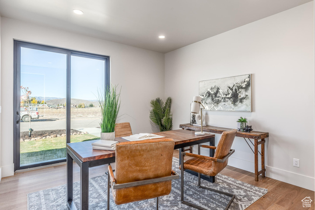 Home office with plenty of natural light and hardwood / wood-style floors