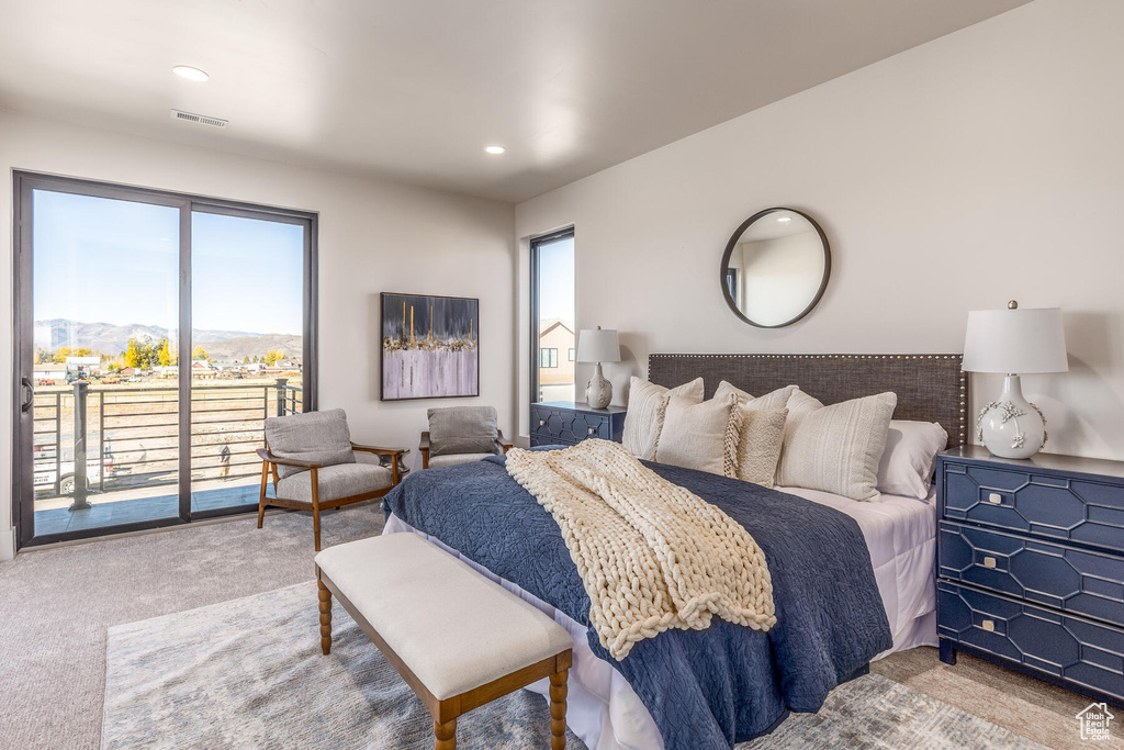 Bedroom featuring carpet flooring, a mountain view, and access to exterior