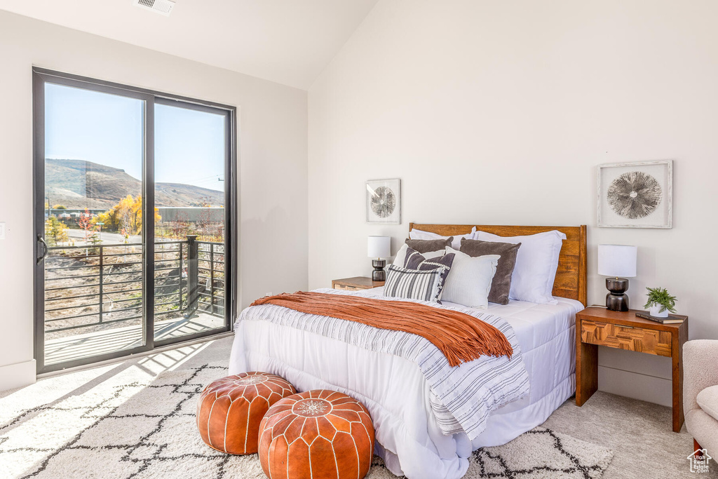 Carpeted bedroom featuring access to outside, a mountain view, and vaulted ceiling