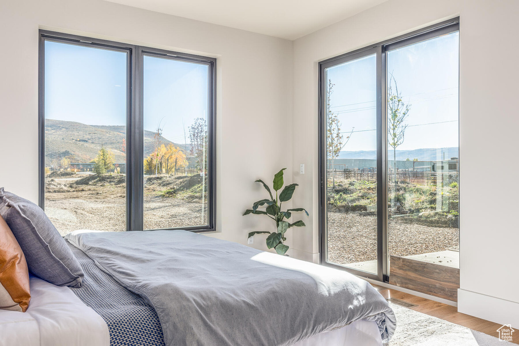 Bedroom with a mountain view and hardwood / wood-style flooring