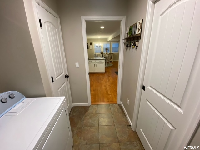 Laundry room featuring dark tile flooring and washer / clothes dryer