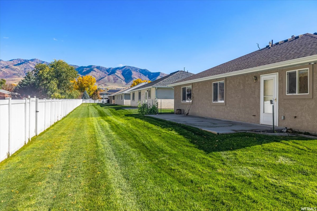 View of yard featuring a patio area and a mountain view