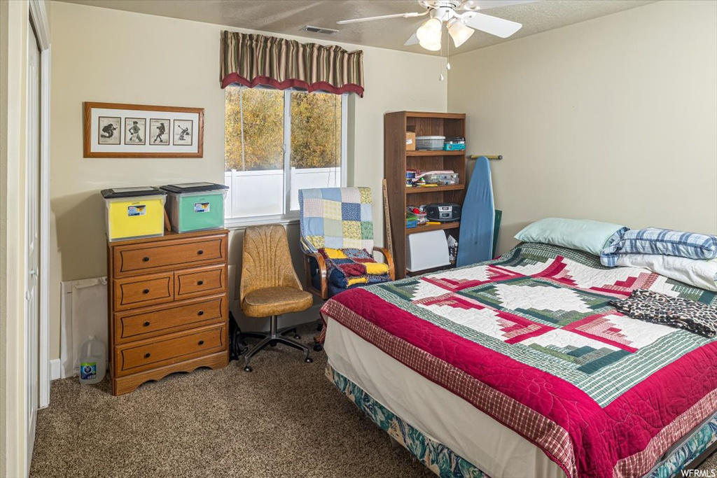 Carpeted bedroom with ceiling fan