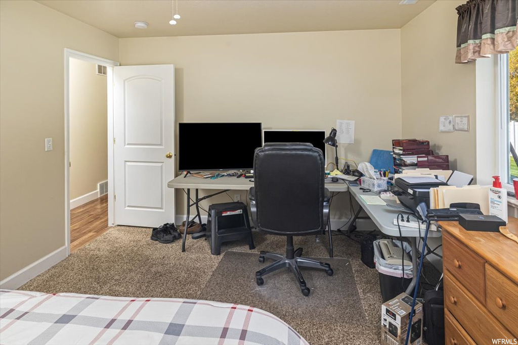 Office area featuring dark carpet