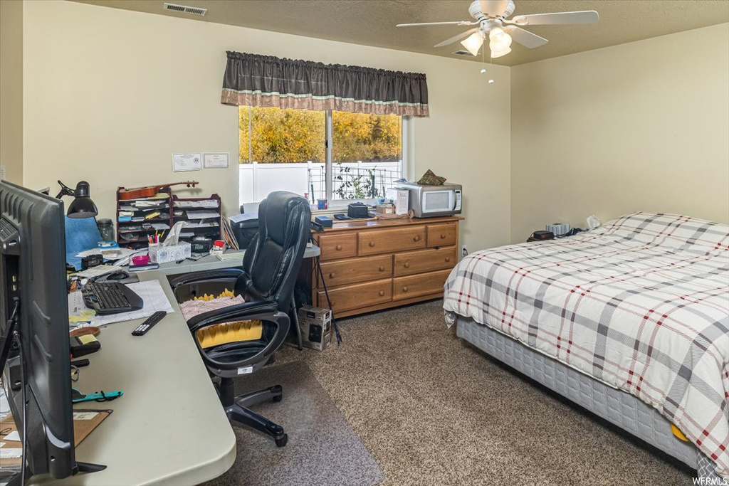 Carpeted bedroom with ceiling fan