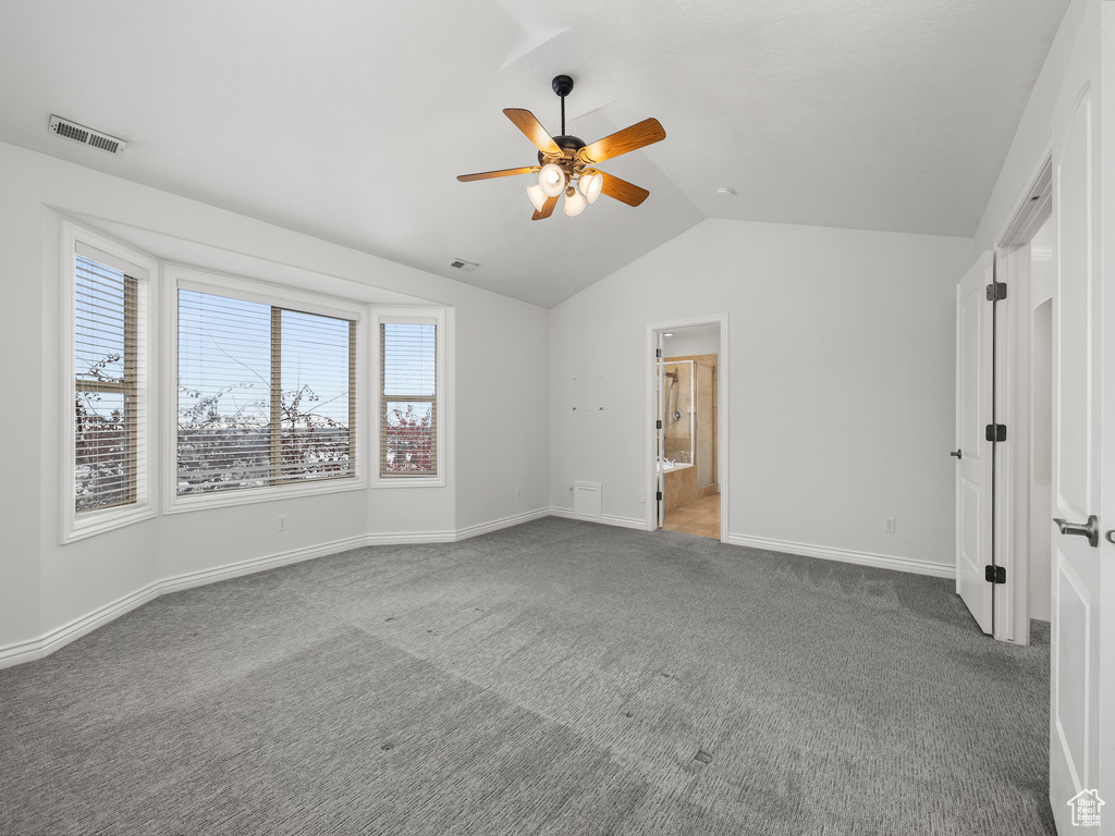 Unfurnished room with vaulted ceiling, light colored carpet, and ceiling fan