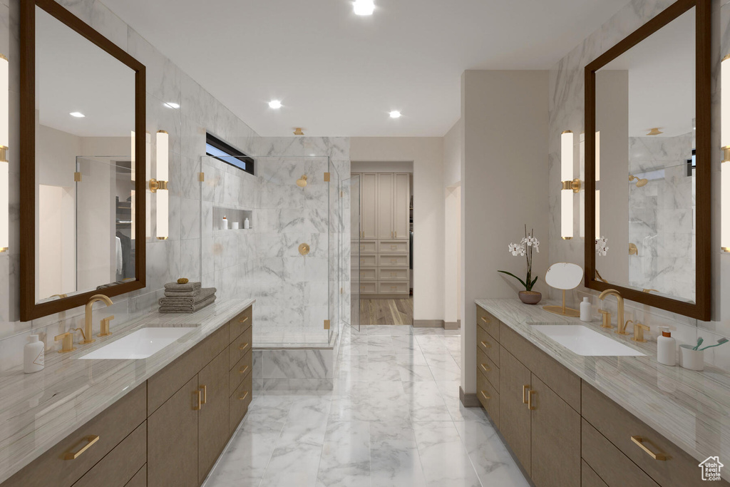 Bathroom with tile walls, a shower with door, backsplash, and tile flooring