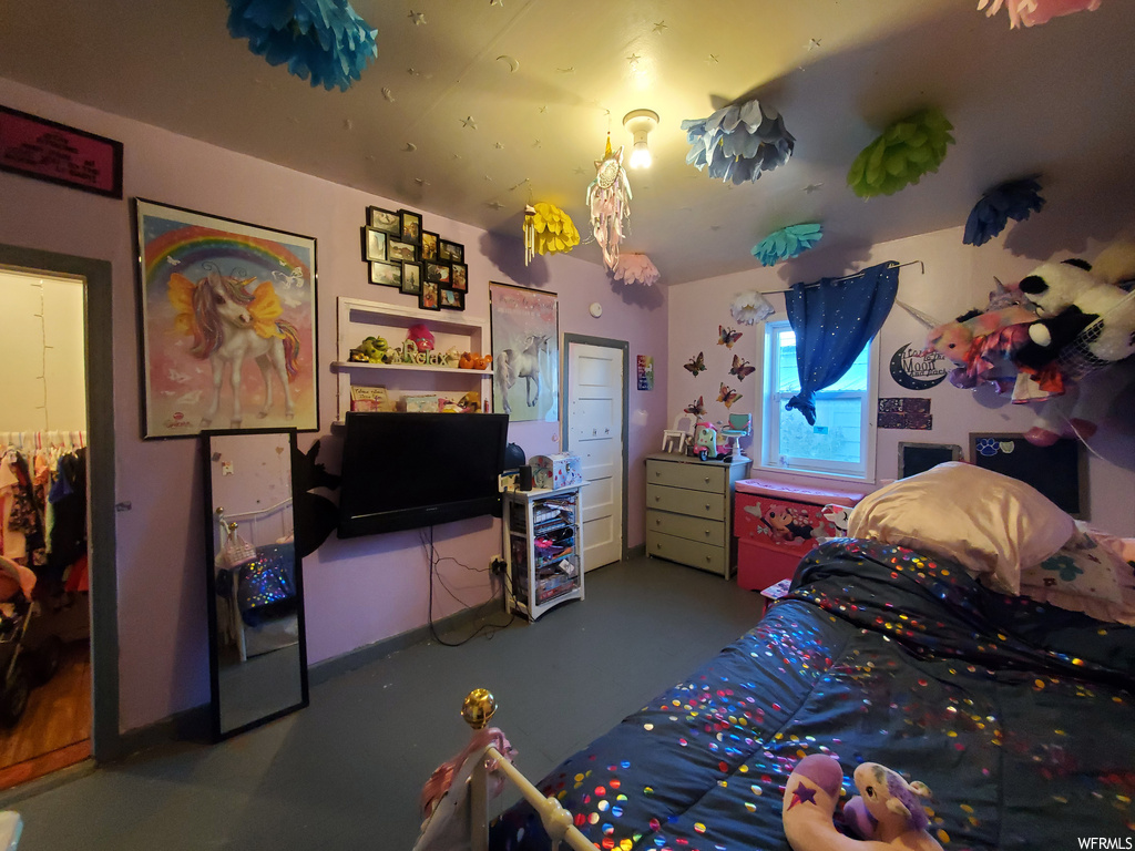 Bedroom featuring dark colored carpet