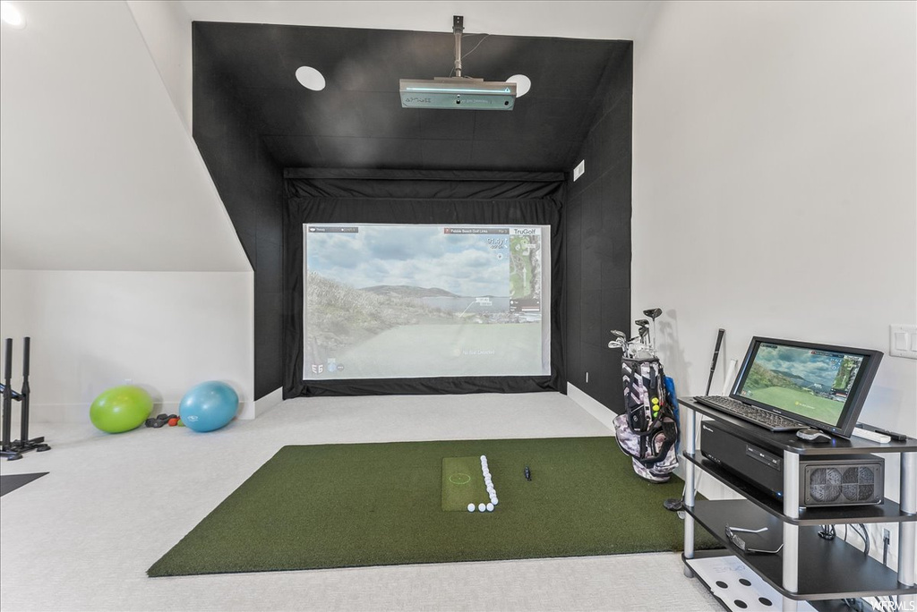 Game room featuring golf simulator and carpet floors