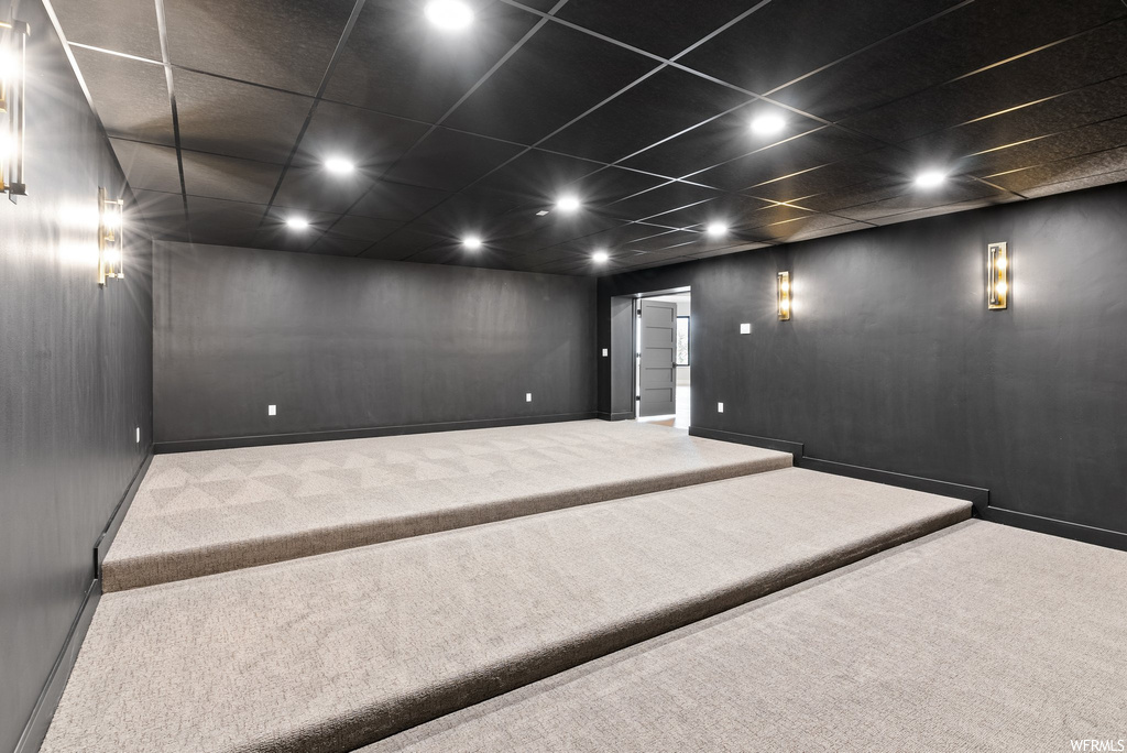Home theater room with a drop ceiling and carpet floors