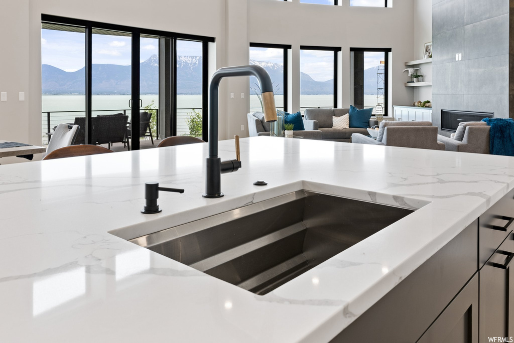 Room details with sink, a water and mountain view, and a fireplace