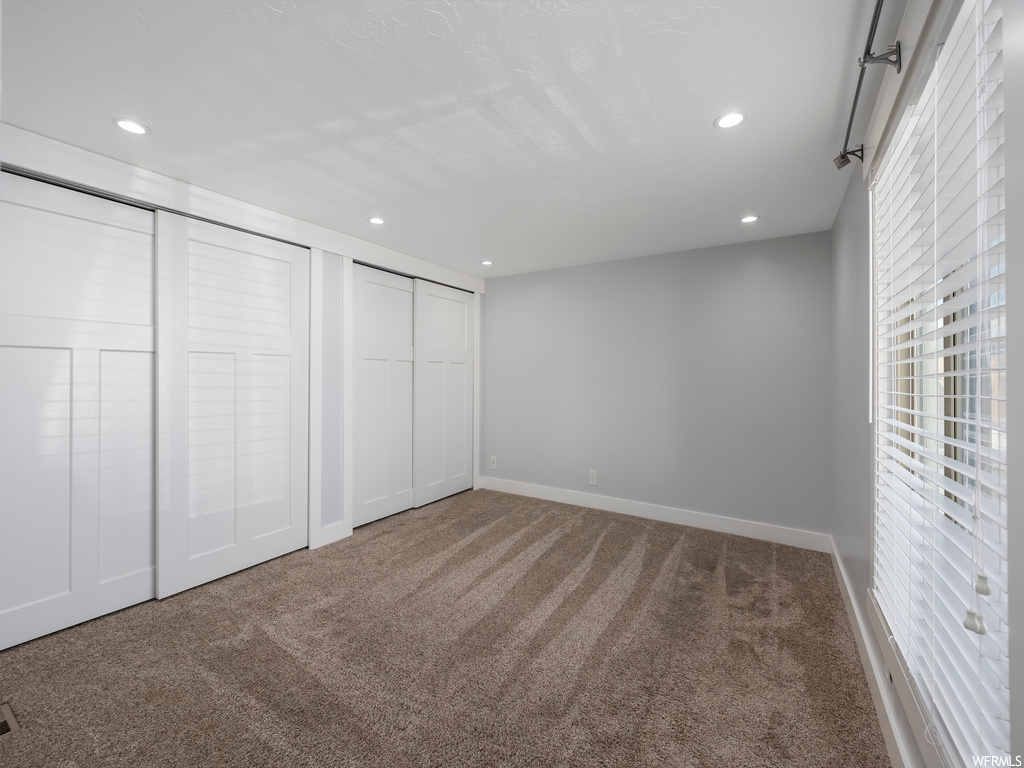 Unfurnished bedroom featuring carpet