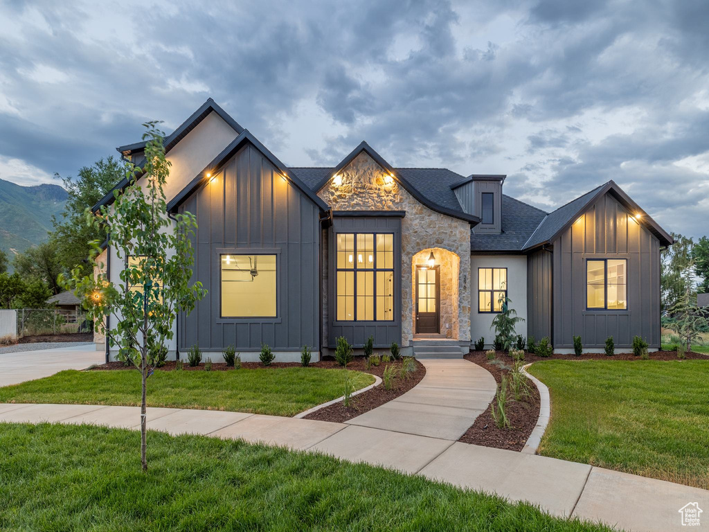 Modern farmhouse style home featuring a front lawn