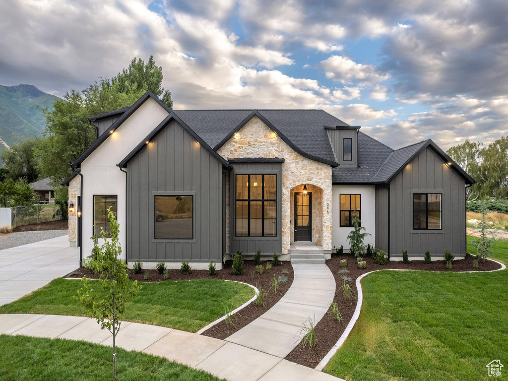 Modern inspired farmhouse with a front lawn