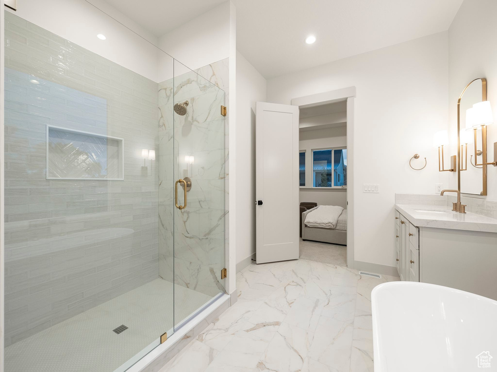 Bathroom featuring a shower with shower door, vanity, and tile patterned floors