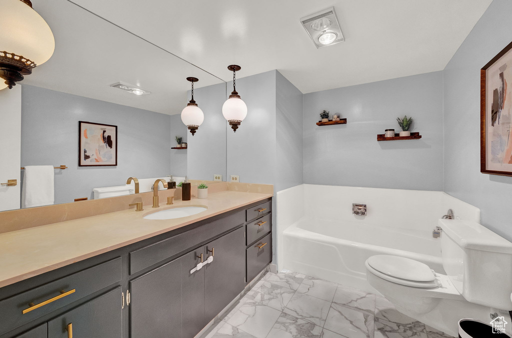 Bathroom featuring a bath, vanity, toilet, and tile floors