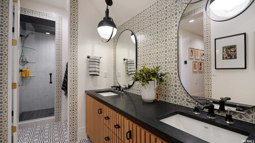 Bathroom with tile flooring, dual bowl vanity, and walk in shower
